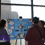 Students stop to read poster presentation